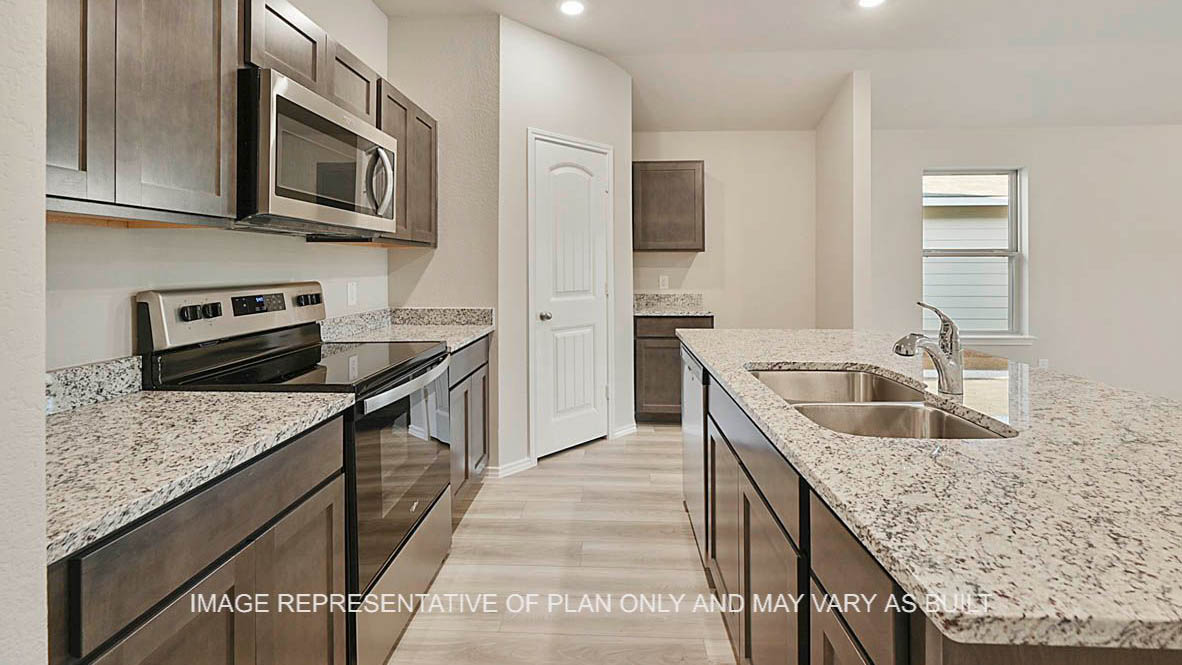 Elgin kitchen with stained cabinetry, granite countertops, kitchen island, and vinyl plank flooring.