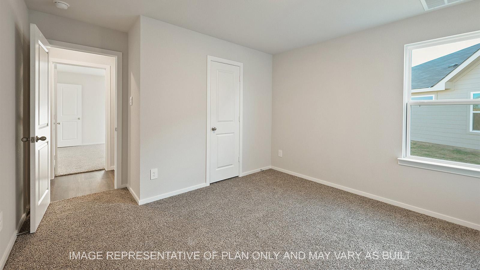 Lakeway secondary bedroom with window, closet, and carpeted flooring.