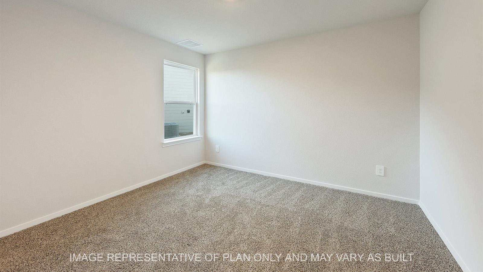 Lakeway secondary bedroom with carpeted flooring and window.