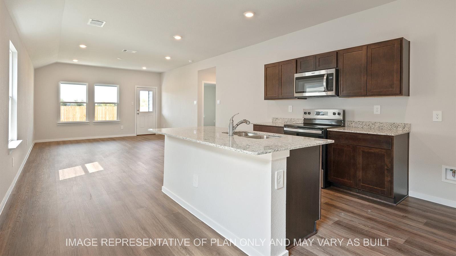 Caroline kitchen with dark stained cabinetry, granite countertops, and vinyl plank flooring.
