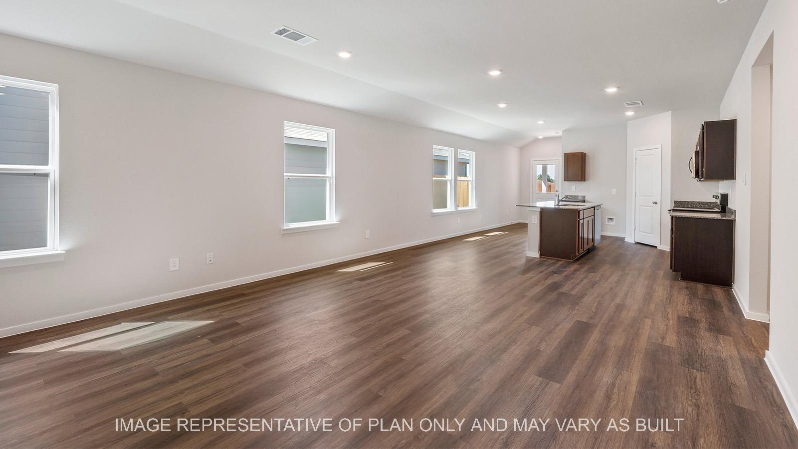 Diana open-concept living room with windows and view to kitchen.