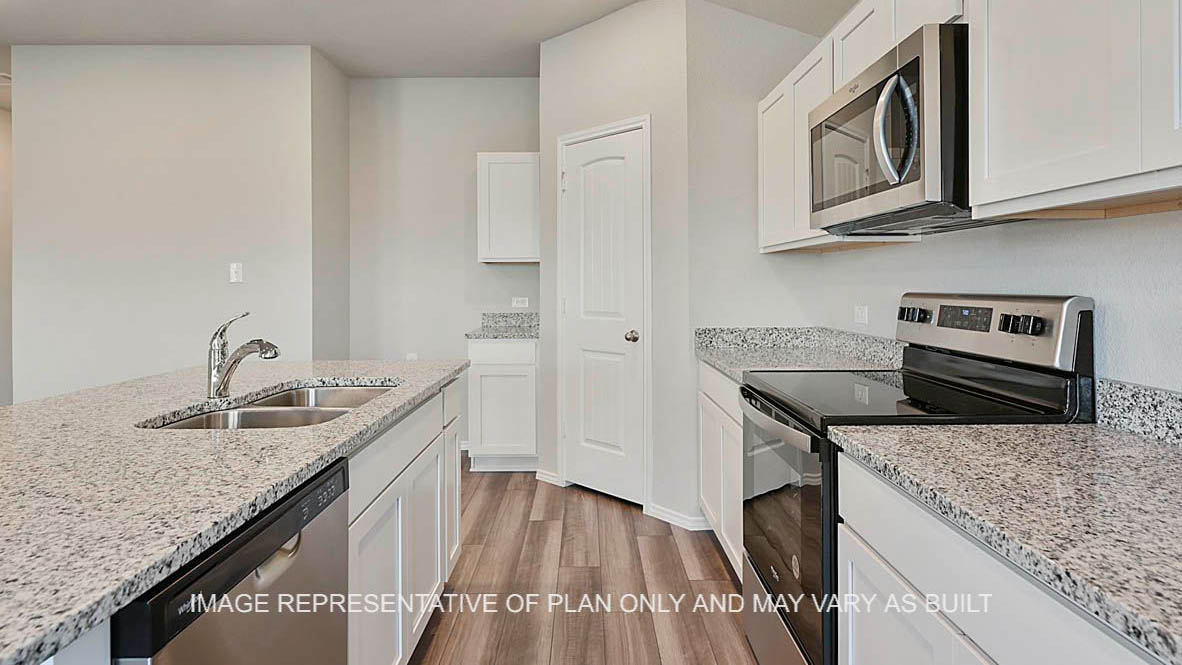 Bellvue kitchen with granite countertops, white cabinetry, and vinyl plank flooring.