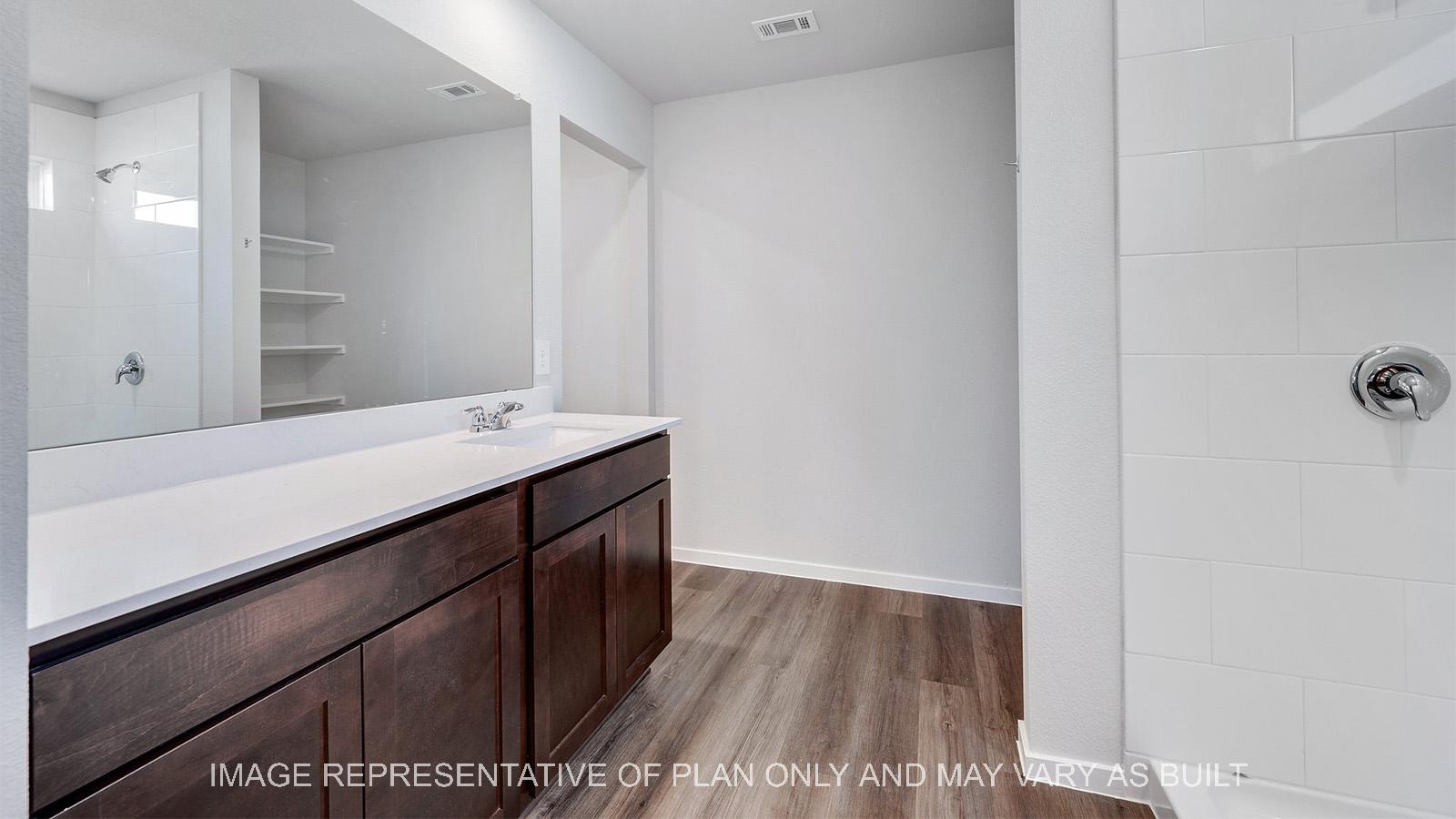 Camden primary bathroom with ceramic tile shower surround.