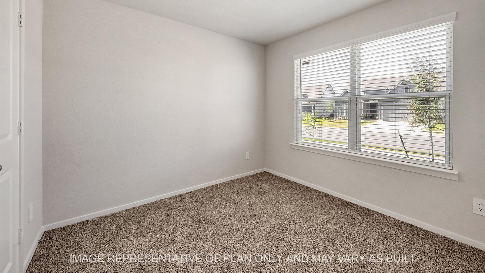 Camden secondary bedroom with windows and carpeted flooring.