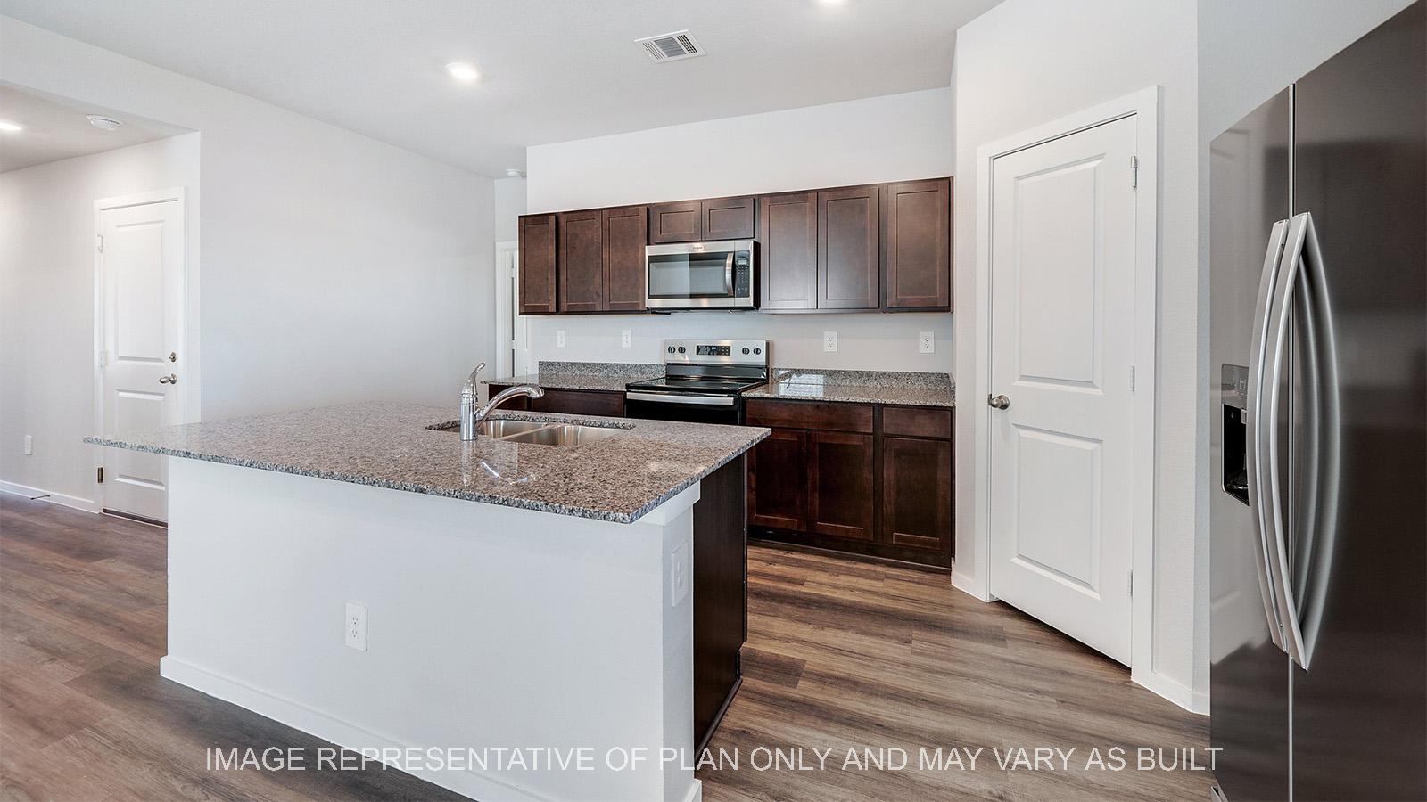 Camden kitchen with corner pantry and stainless steel appliances.