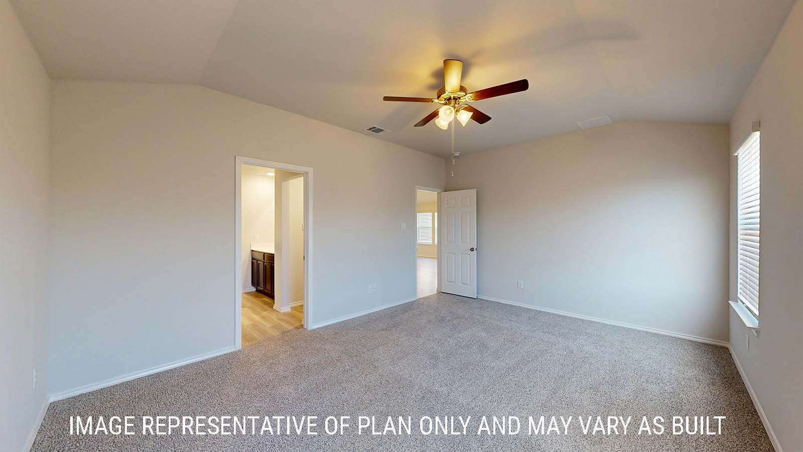 Caden primary bedroom with carpeted flooring and view of primary bathroom.