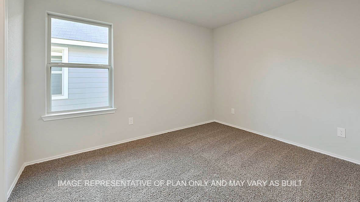 Bellvue secondary bedroom with carpeted flooring and window.