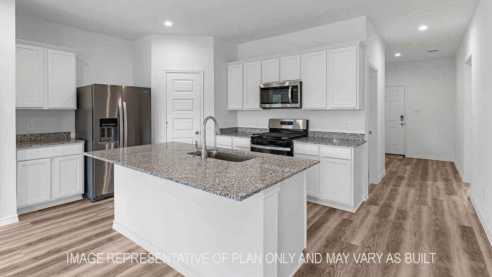 Denton kitchen with stainless steel appliances, island, corner pantry, granite countertops, and white shaker cabinetry.