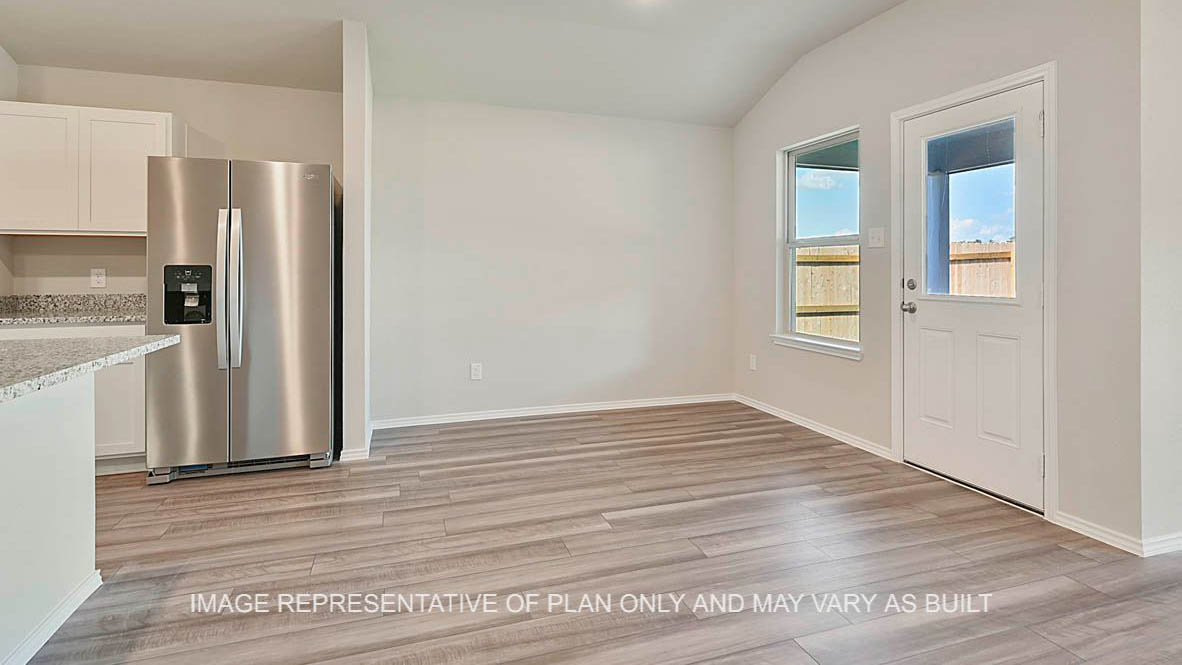 Texas Cali dining room with windows and vinyl plank flooring.