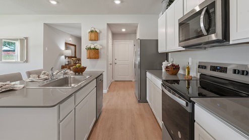Wilkins Valley open concept kitchen with gray quartz countertops and stainless-steel appliances.