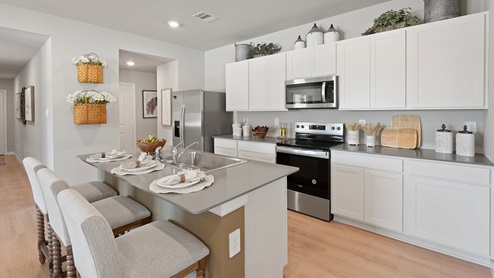 Wilkins Valley open concept kitchen with gray quartz countertops and stainless-steel appliances.
