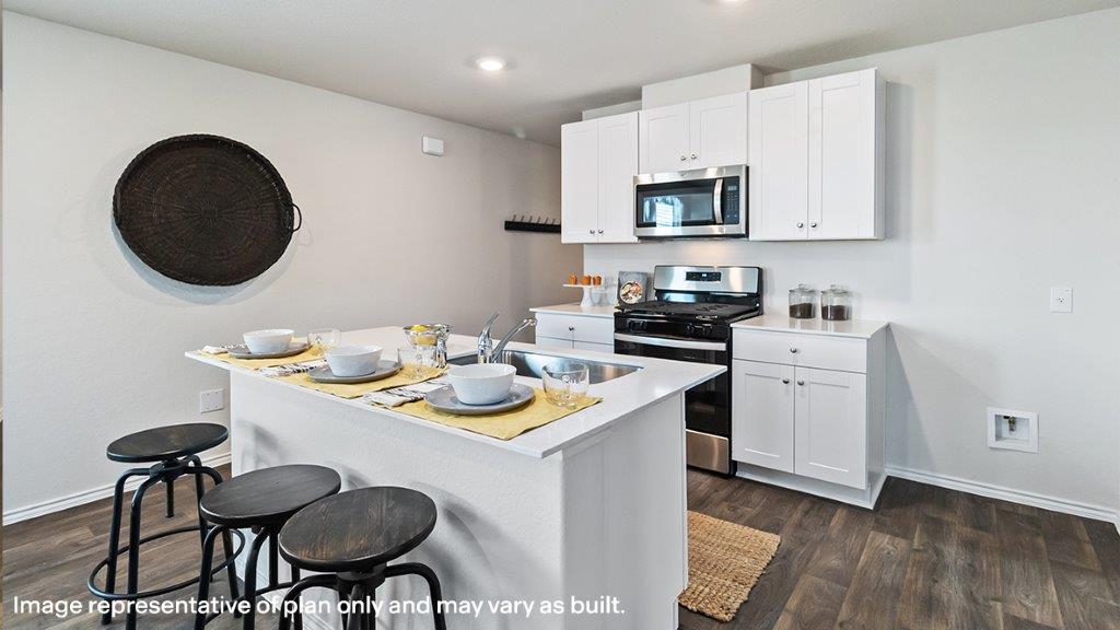 Barton kitchen with white cabinets and granite countertops.