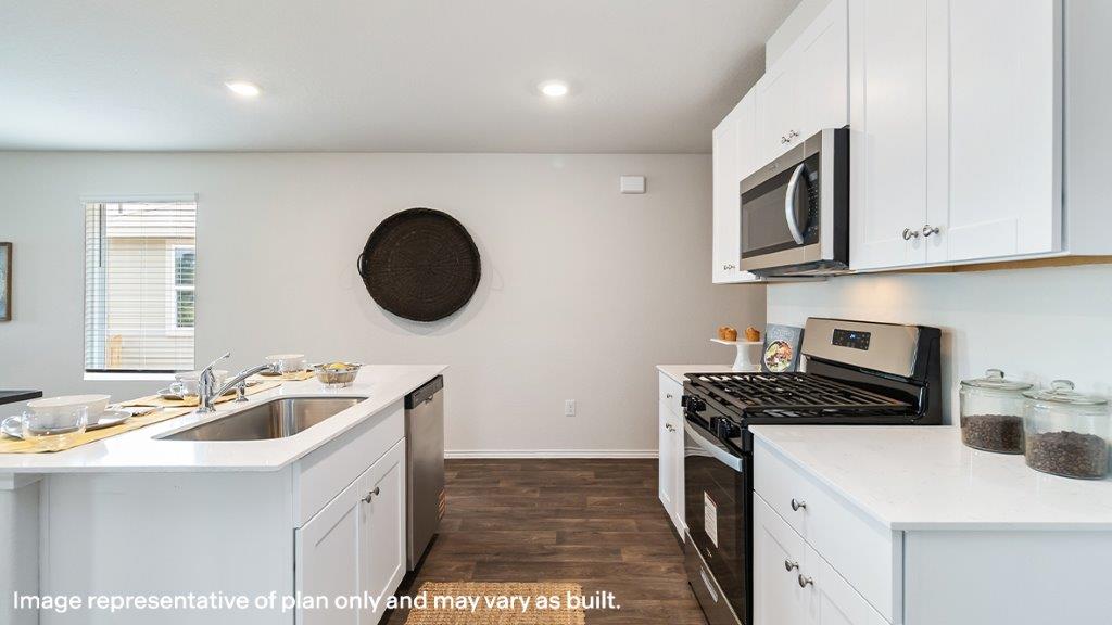 Barton kitchen with white cabinets and granite countertops.