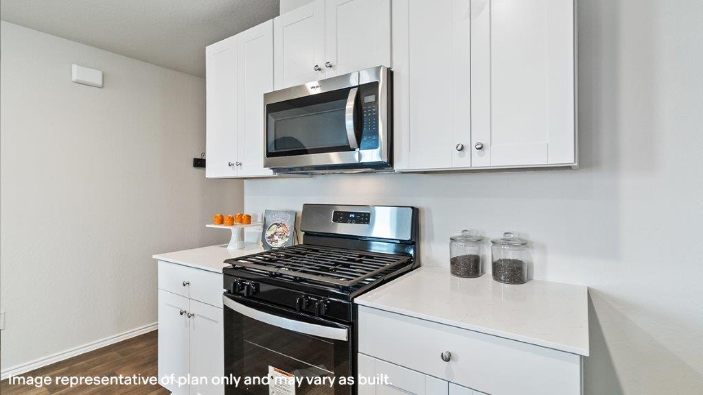 Barton kitchen with white cabinets and granite countertops.