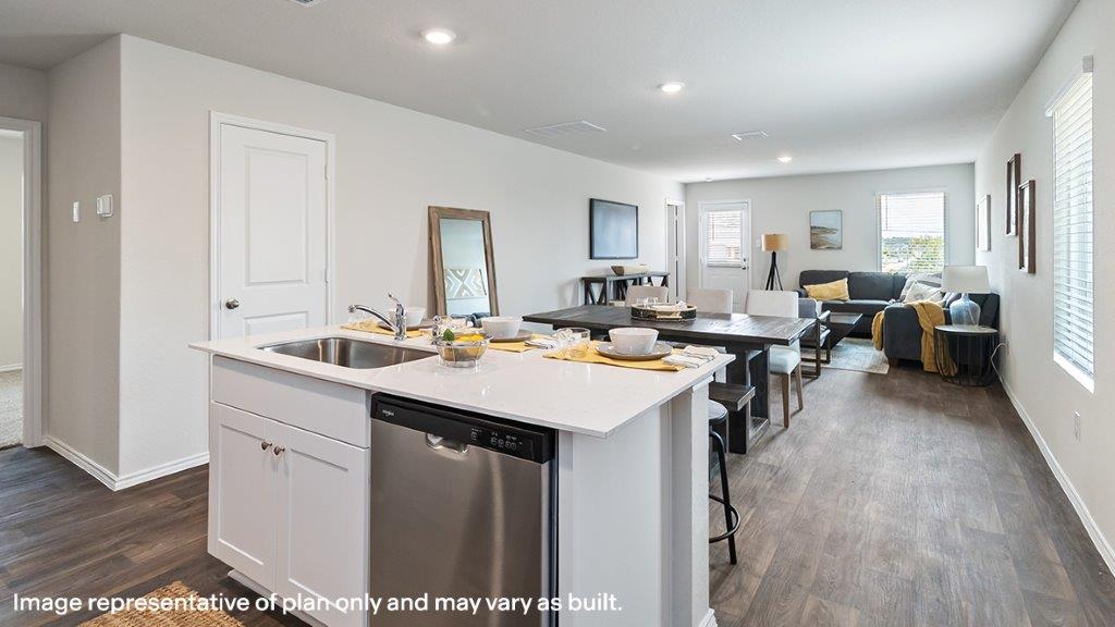 Barton kitchen with center kitchen island and view of dining room and living room.