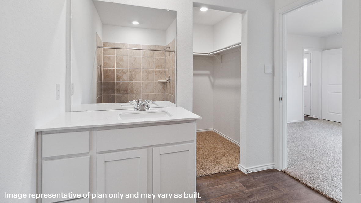 Caprock primary bathroom with single vanity and view of walk-in closet.