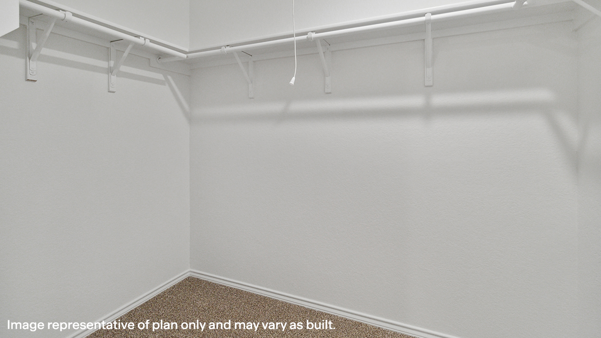 Caprock primary walk-in closet with carpeted flooring and shelving.