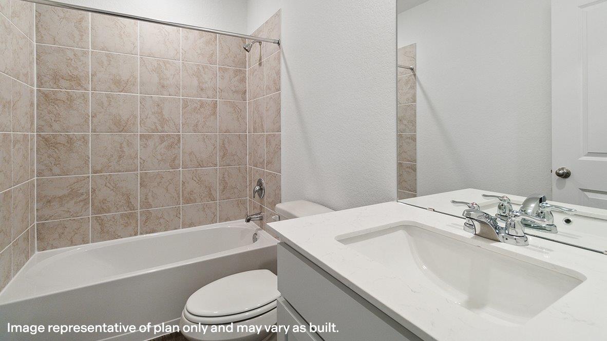 Caprock secondary bathroom with single vanity and bath tub and shower combo.