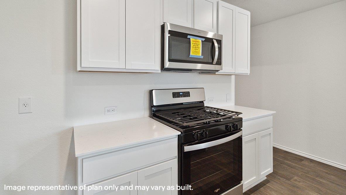 Caprock kitchen with white cabinets and granite countertops.
