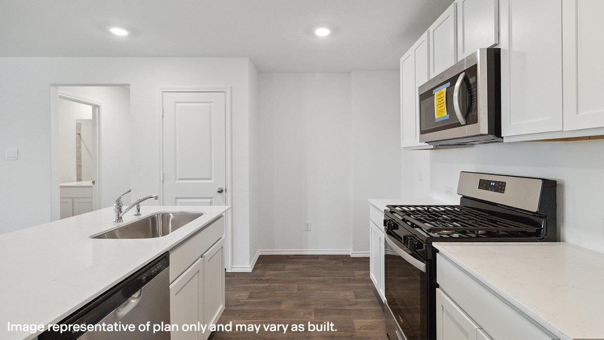 Caprock kitchen with white cabinets and granite countertops.