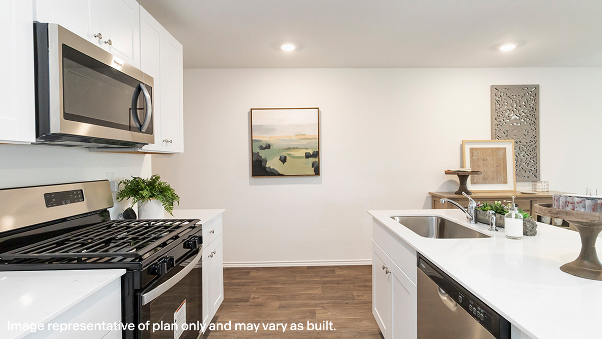 Estero kitchen white cabinets and granite countertops.