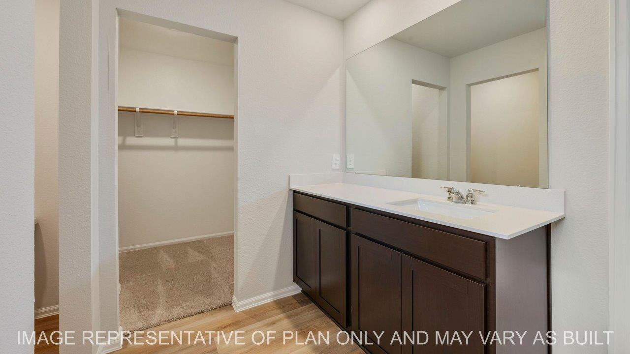 Abbot primary bathroom with quartz vanity and walk-in closet