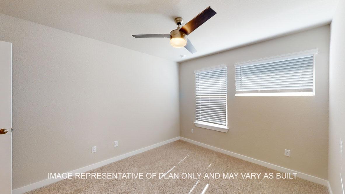 Baxtor secondary bedroom with carpet flooring.