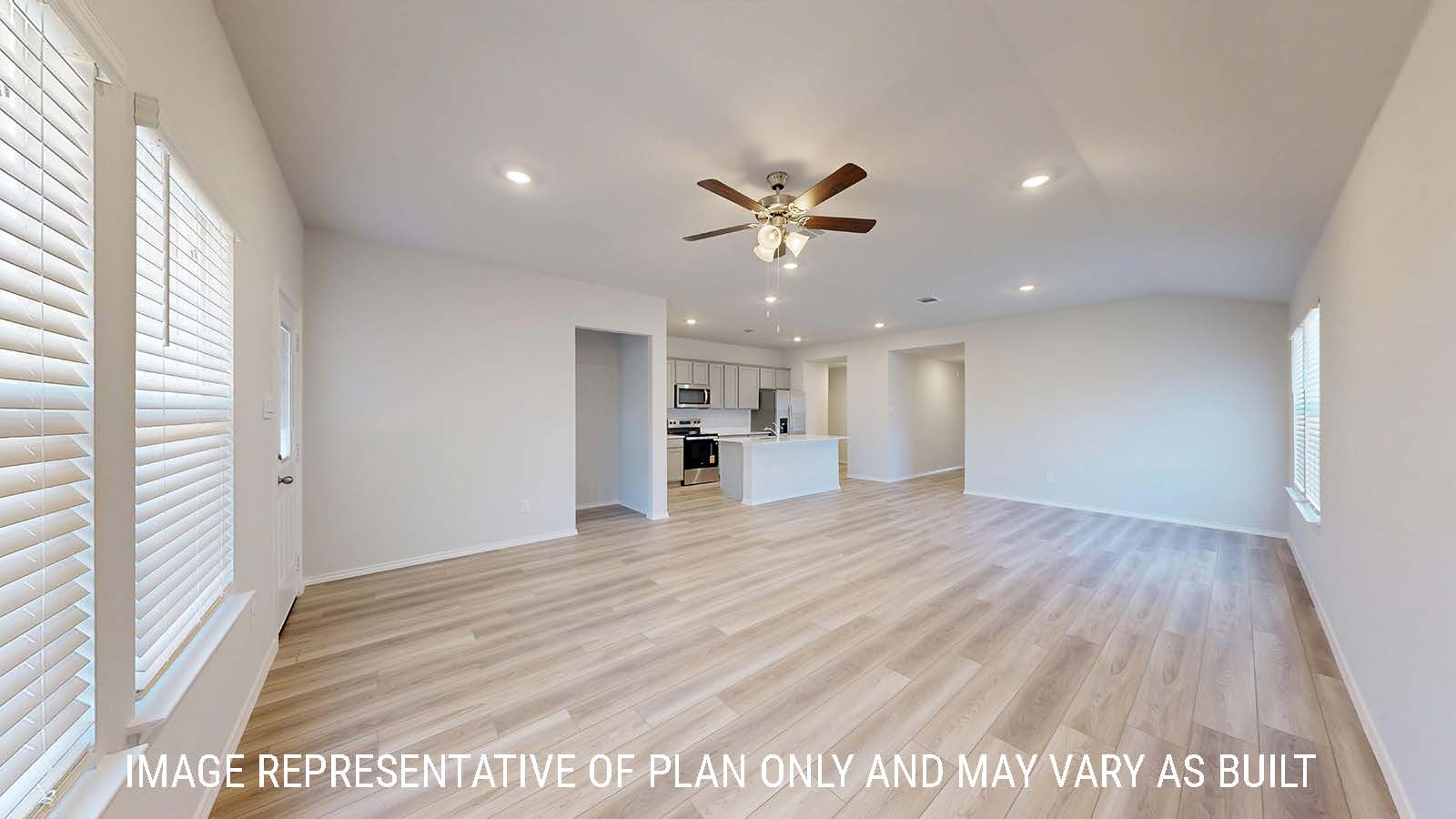 Caden living room with vinyl plank flooring and view of open concept dining room and kitchen.