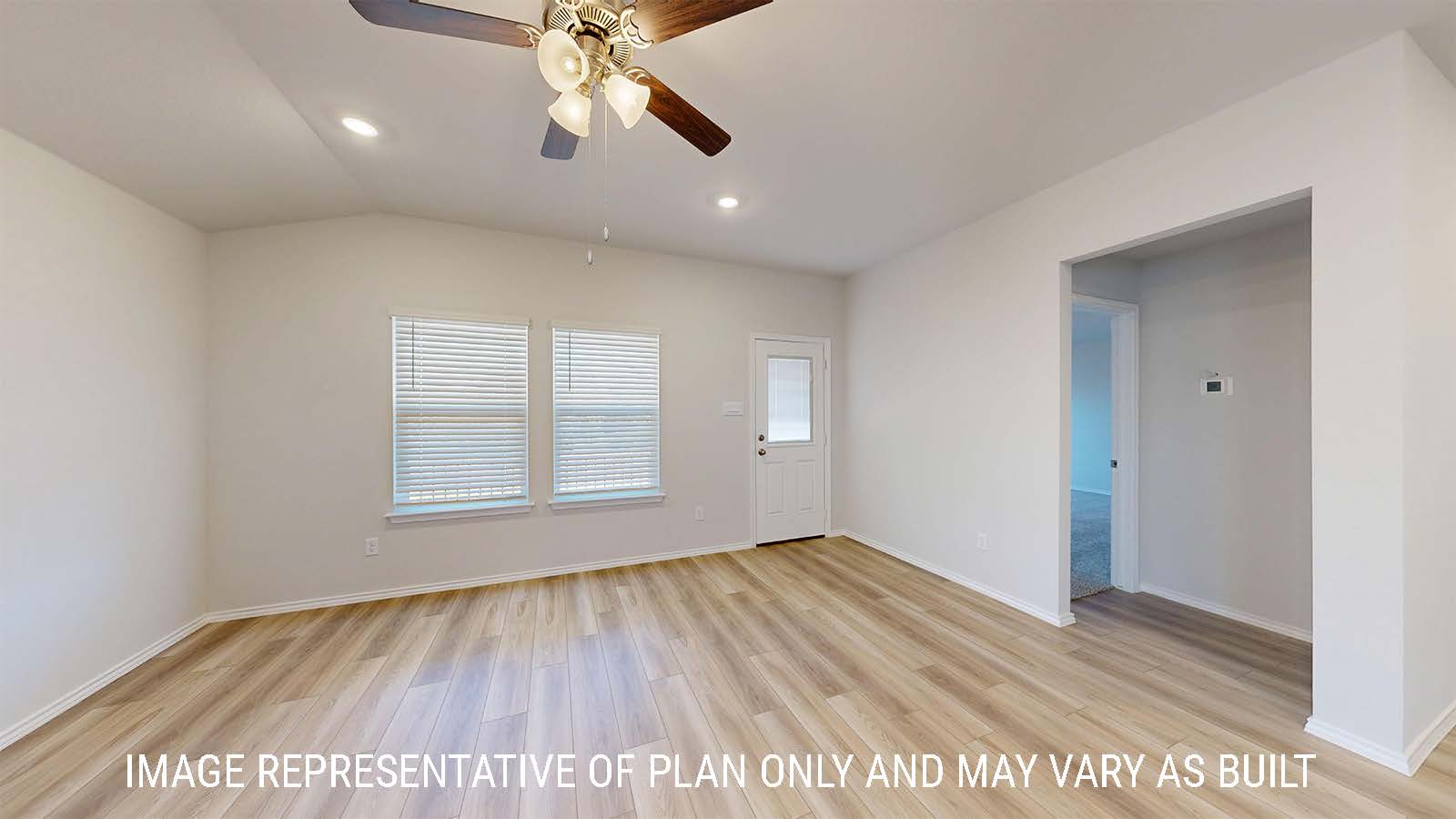 Caden living room with vinyl plank flooring and windows for natural lighting.