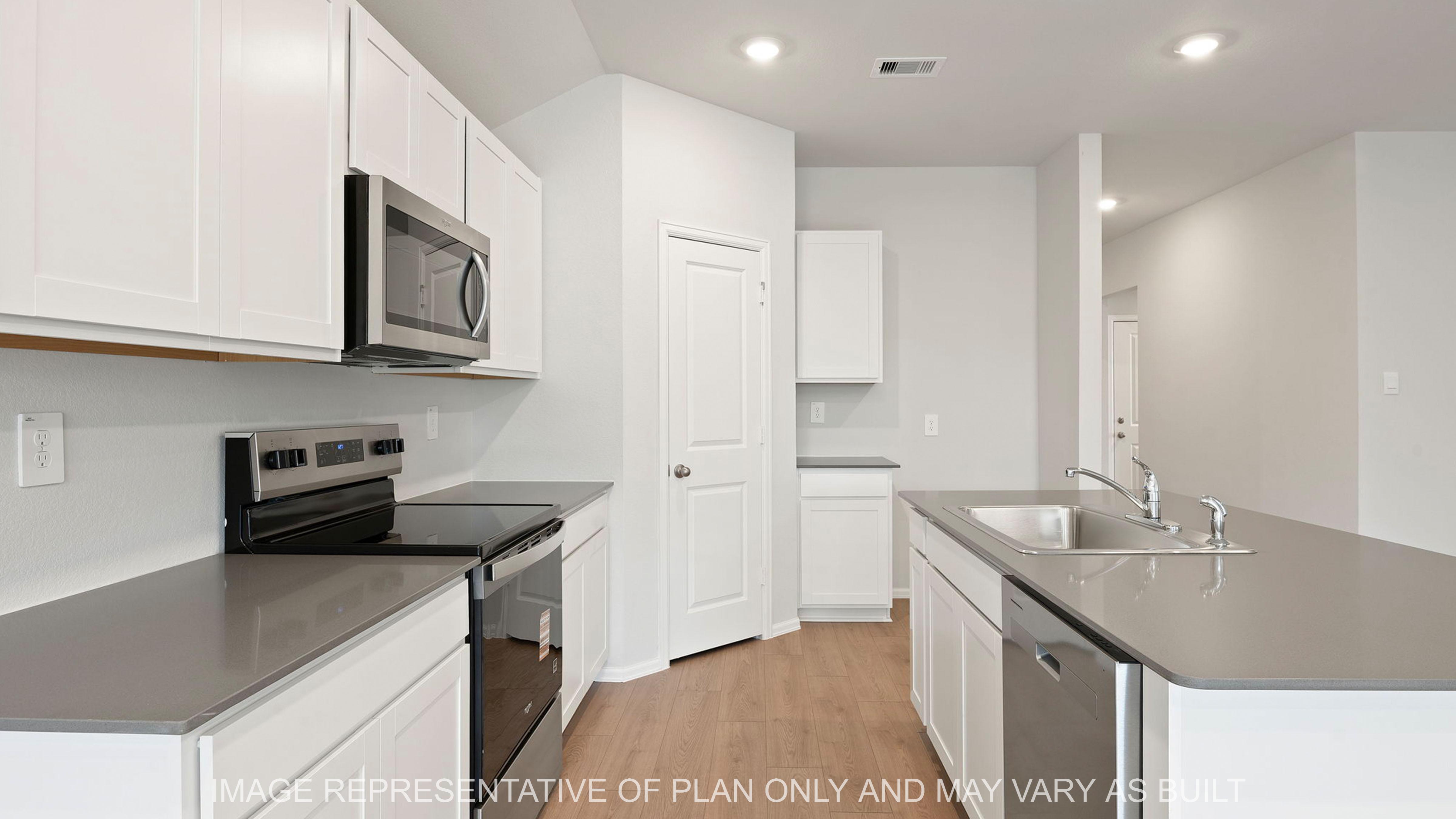Easton open concept kitchen with gray quartz counter tops and white cabinetry