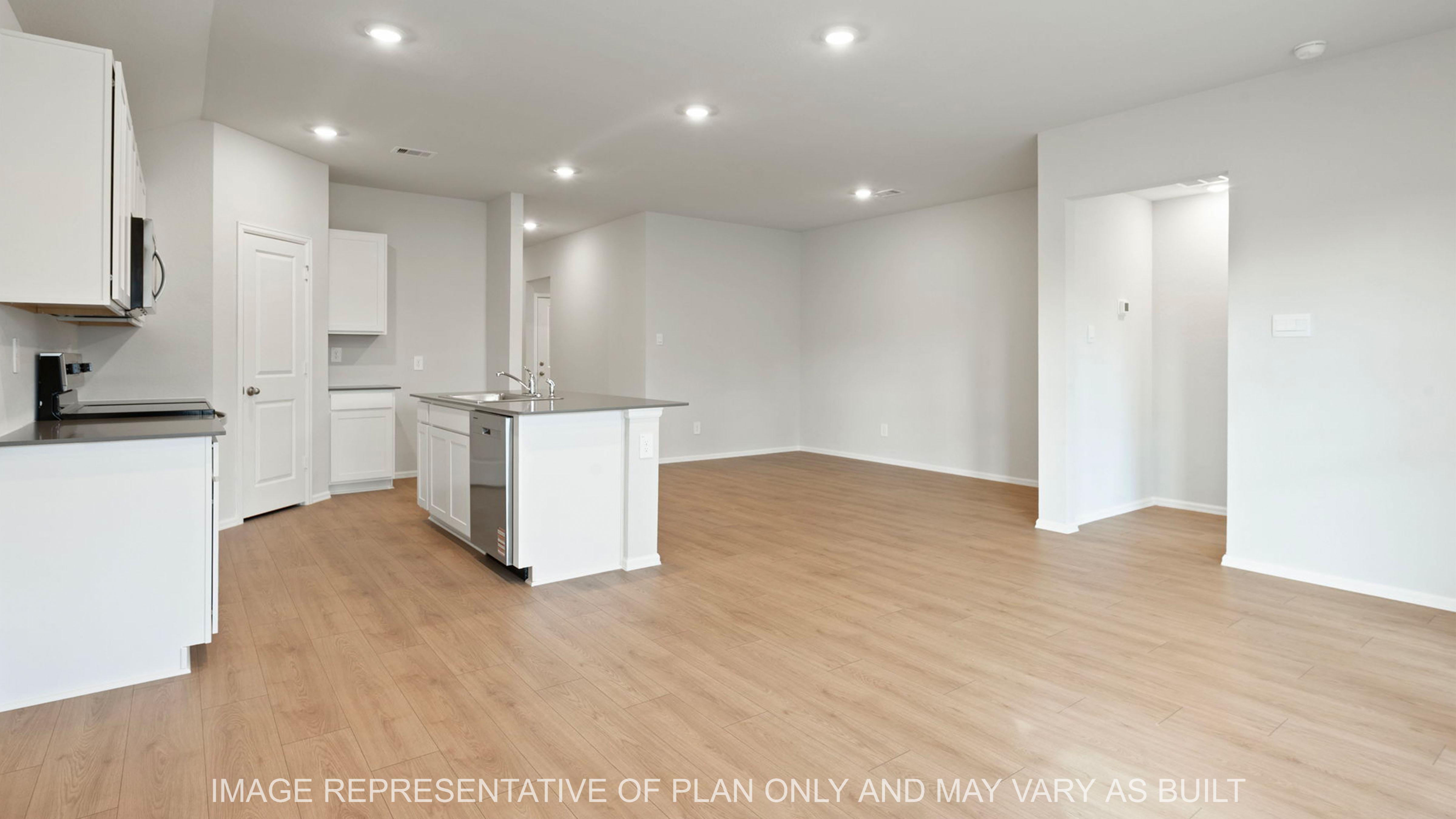 Easton open concept kitchen with gray quartz counter tops and white cabinetry and vinyl flooring