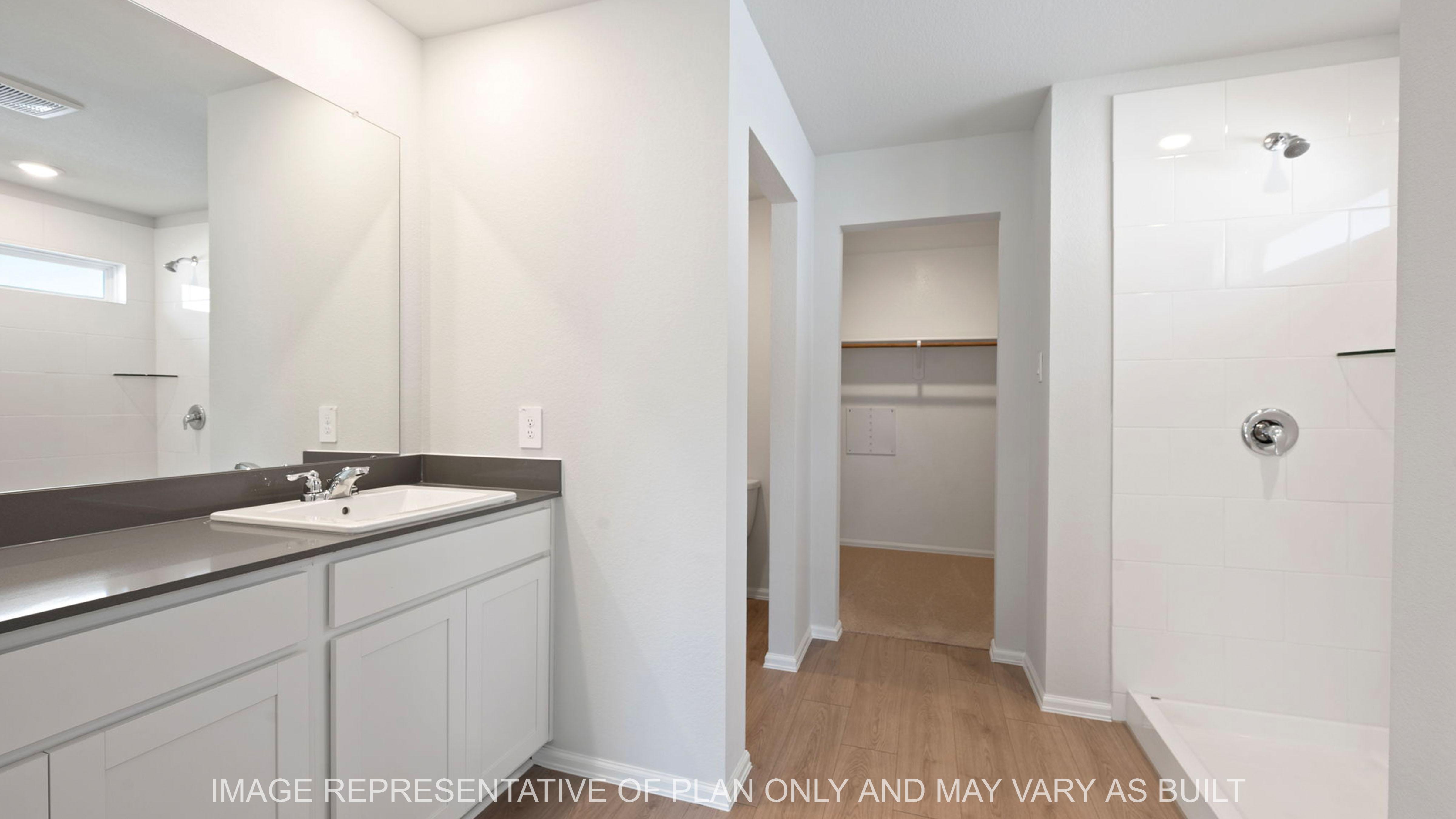 Easton open concept of primary bath with quartz countertops and white cabinetry