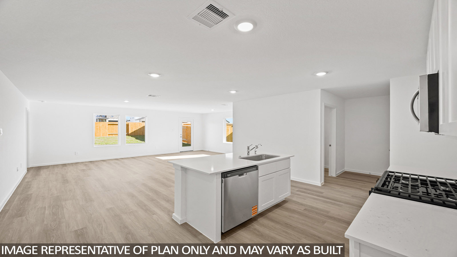 Archer kitchen with white cabinets and light countertops with view of living room.