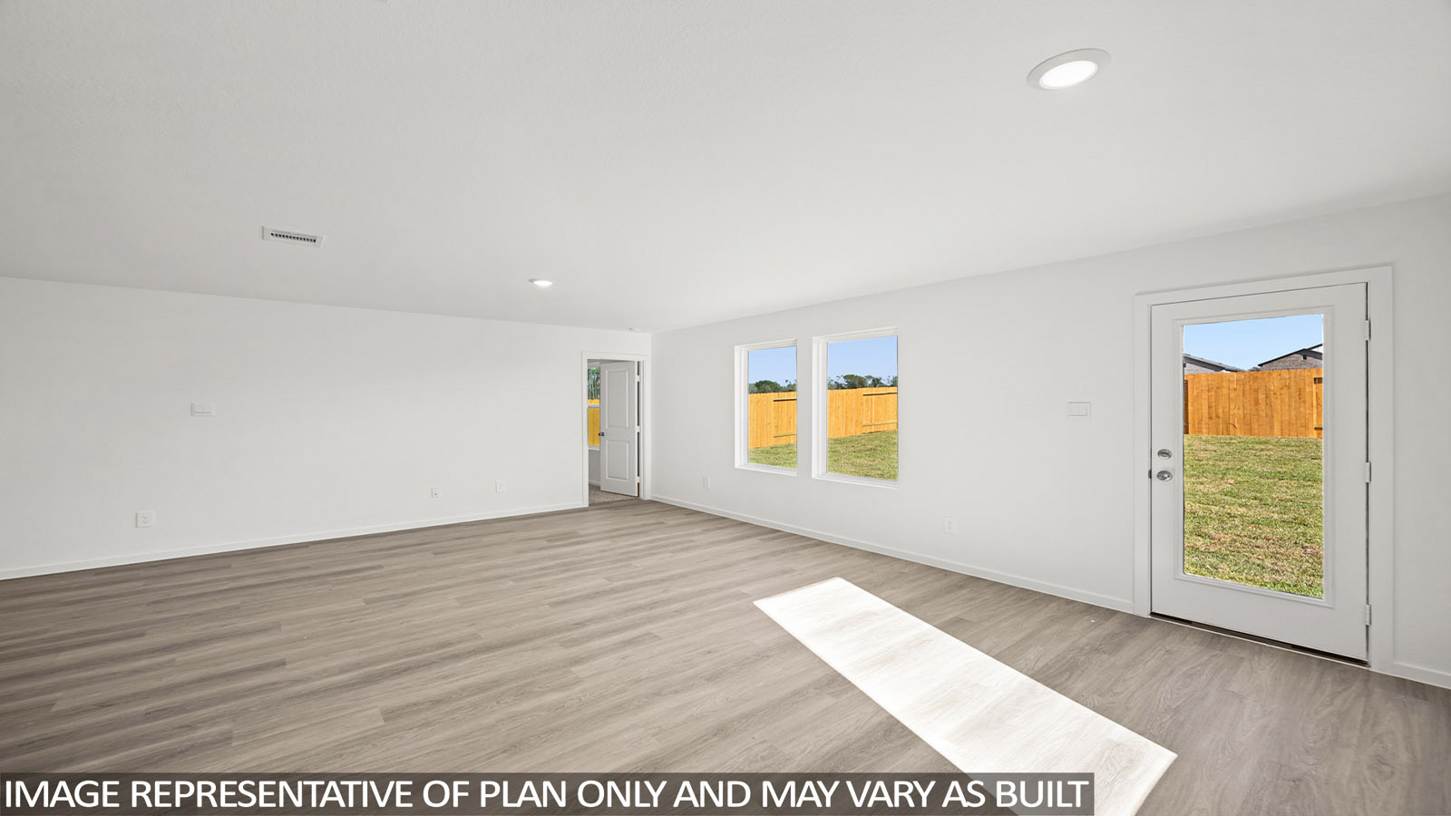 Archer living room with vinyl plank flooring with view of back door and view of primary bedroom.
