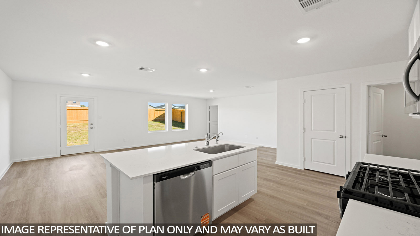 Bradley kitchen with white cabinets and white countertops with view of living room.