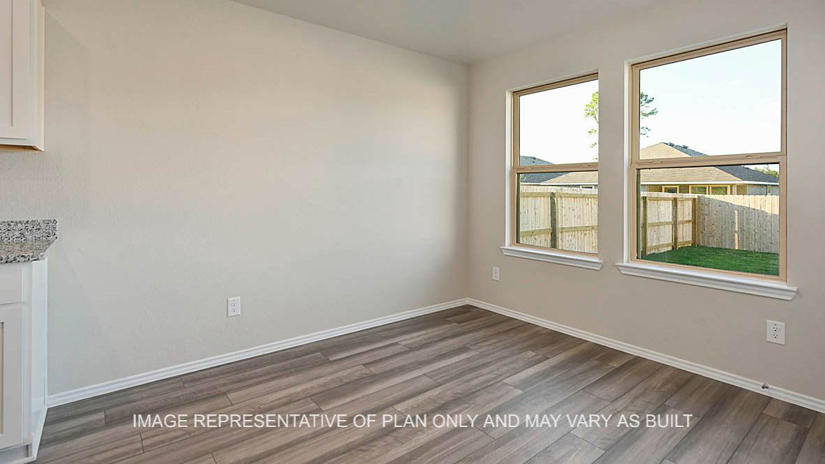 Bellvue open-concept dining room with windows and vinyl plank flooring.