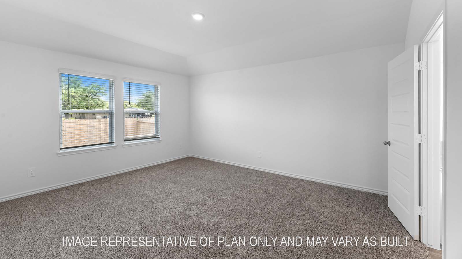 Denton primary bedroom with carpet and two windows.