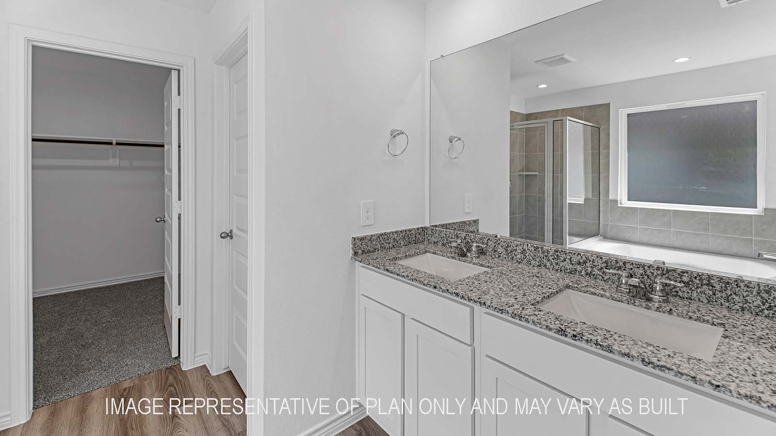 Denton primary bathroom with granite countertops, private toilet, and walk-in closet.