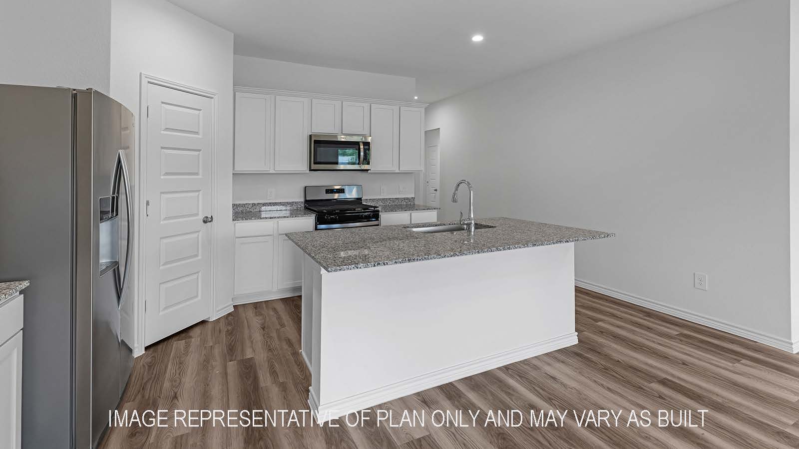 Denton kitchen with stainless steel appliances, island, corner pantry, granite countertops, and white shaker cabinetry.
