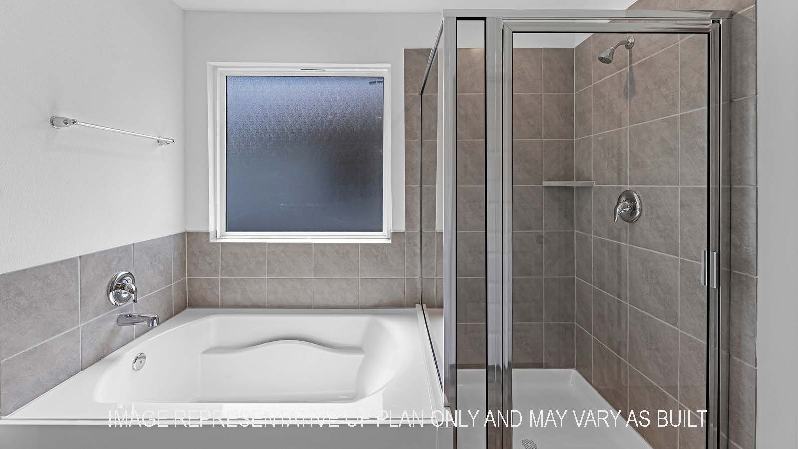Denton primary bathroom with separate walk-in shower and tub.