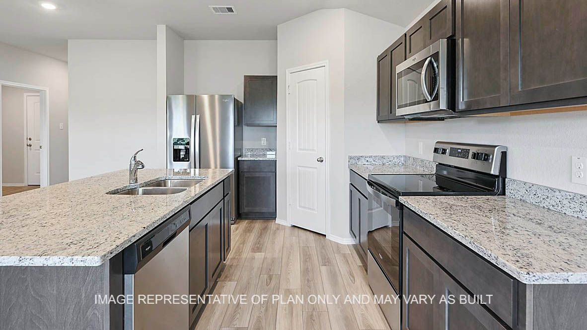 Fargo kitchen with granite countertops, dark stained cabinetry, corner pantry, kitchen island and vinyl plank flooring.