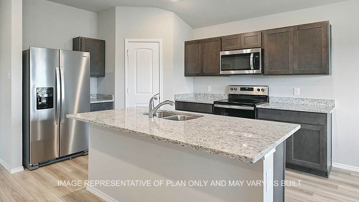 Fargo kitchen with granite countertops, dark stained cabinetry, corner pantry, kitchen island and vinyl plank flooring.