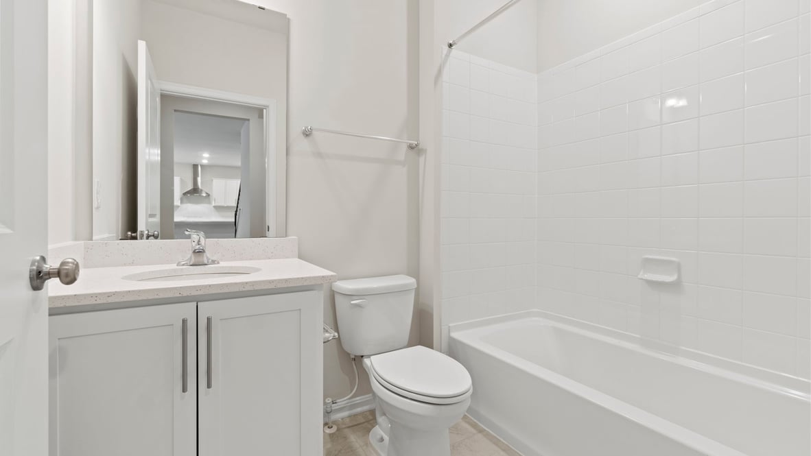 A secondary bathroom with a bathtub
