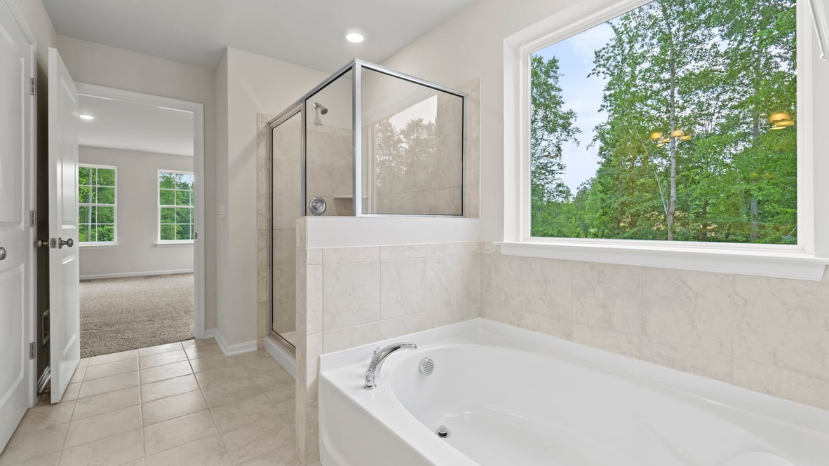 The primary bathroom features separate shower and soaking tub