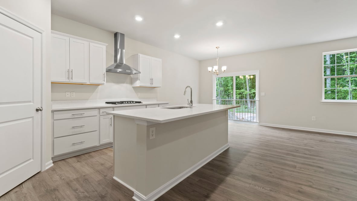 A spacious pantry is located in the corner of the L-shaped kitchen