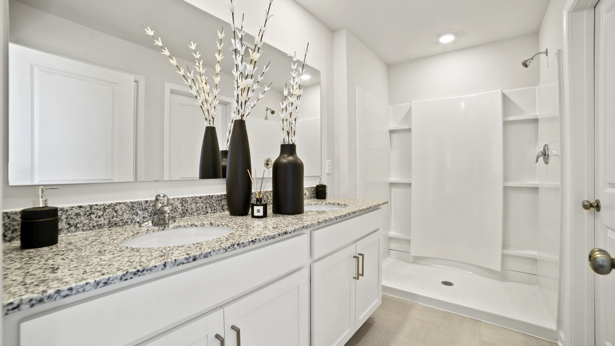 primary full bathroom with double sink vanity and walk in shower