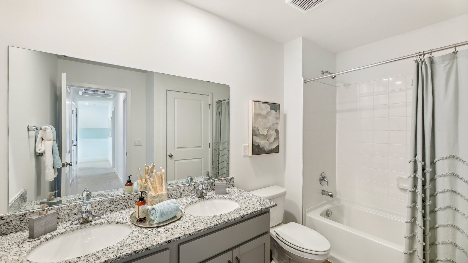 Secondary bathroom comes with a dual vanity and a bathtub