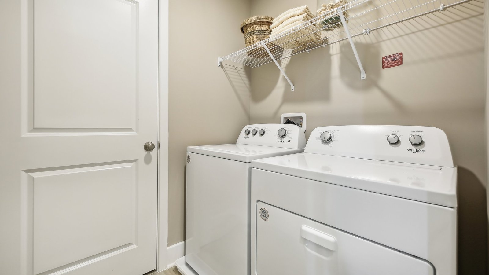 Modern laundry room in a new Winchester VA single-family home featuring functional storage and convenient layout.