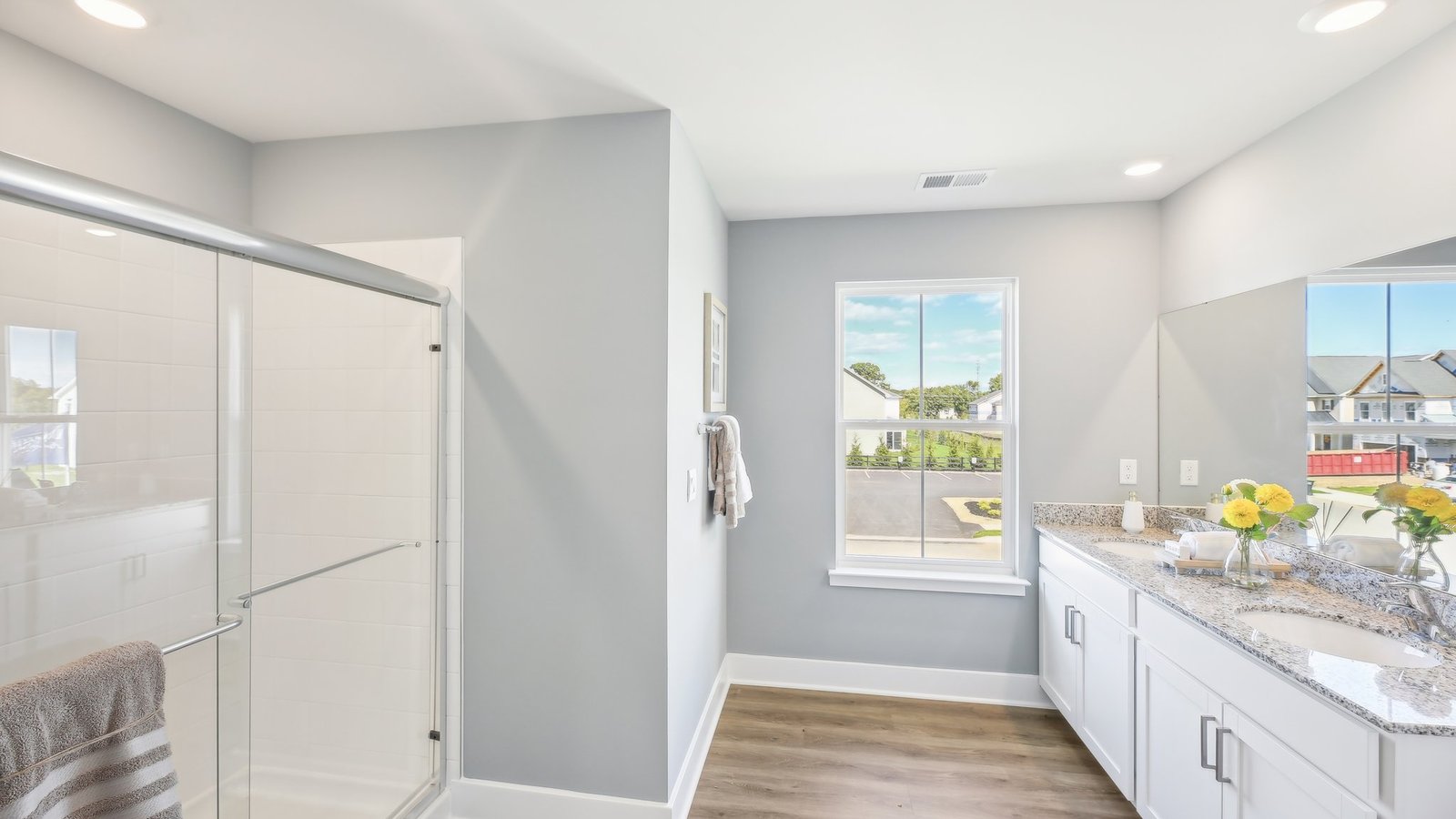 double sink vanity and walk in shower in primary bathroom