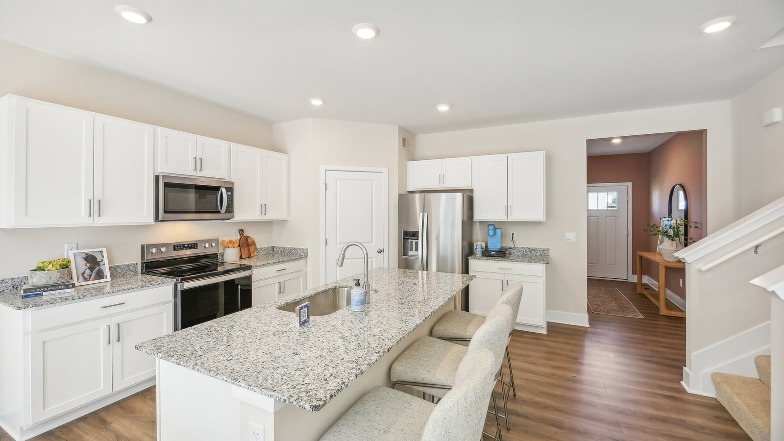 Large center island in a new construction home in Winchester, VA offering additional seating, storage, and meal preparation space.